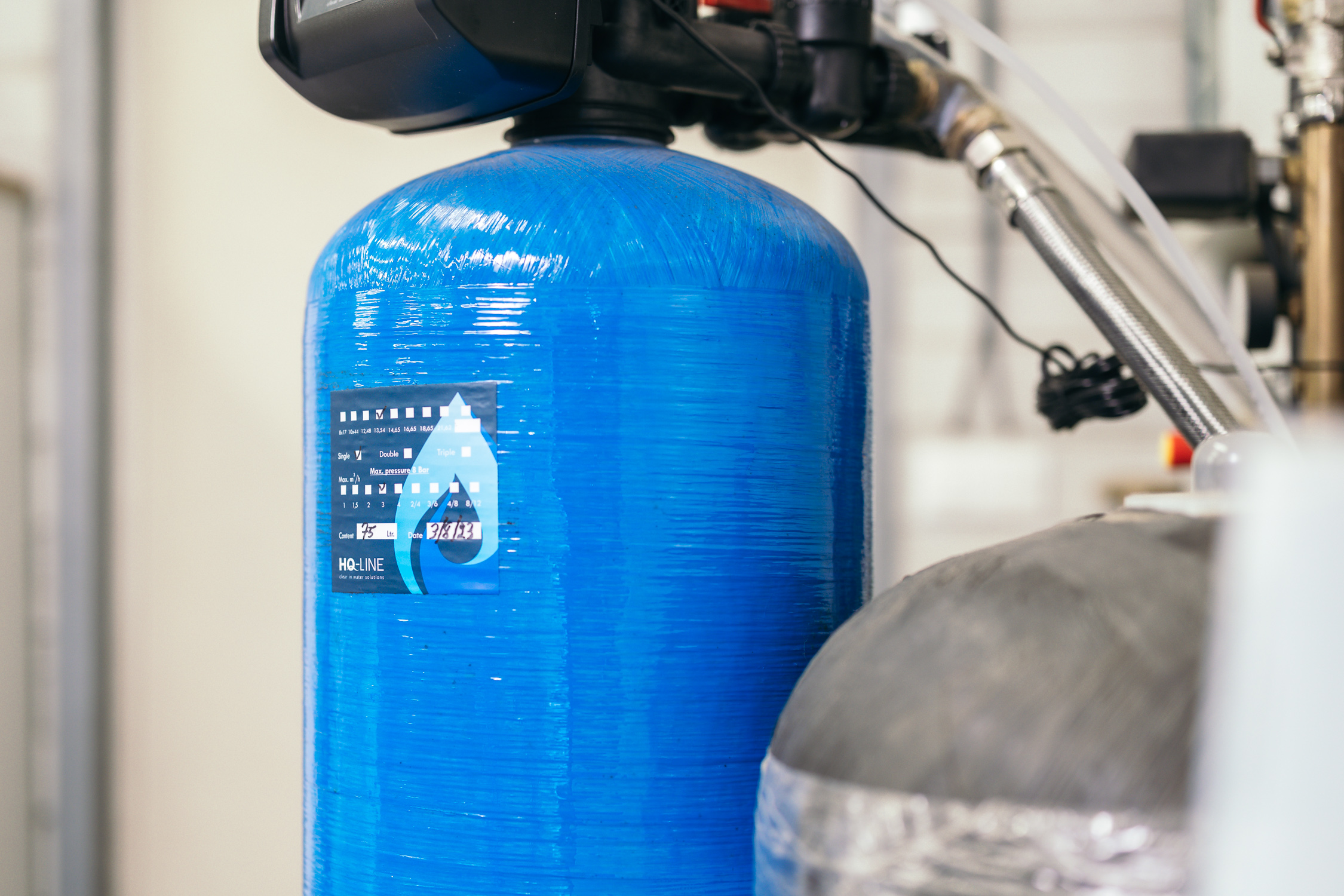 Man Using Measuring Tape in Factory Setting Man Using Measuring Tape in Factory Setting